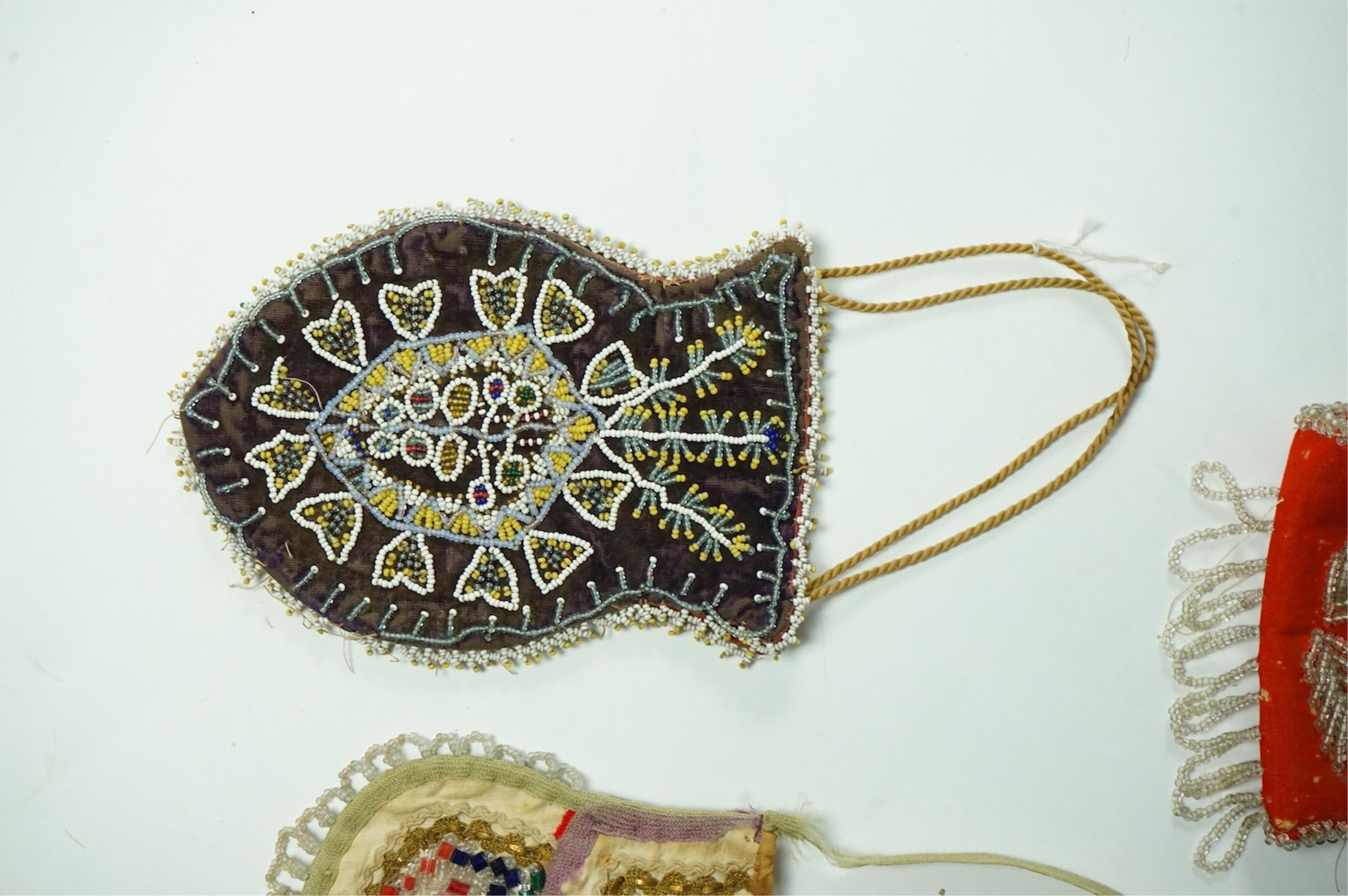 Five 19th century Native American beaded bags. Including a red felt coin pouch, three varying sized bags and a beaded panel.(5) Condition - four have damage to the fringing and beading and backing cloth. The light bag th